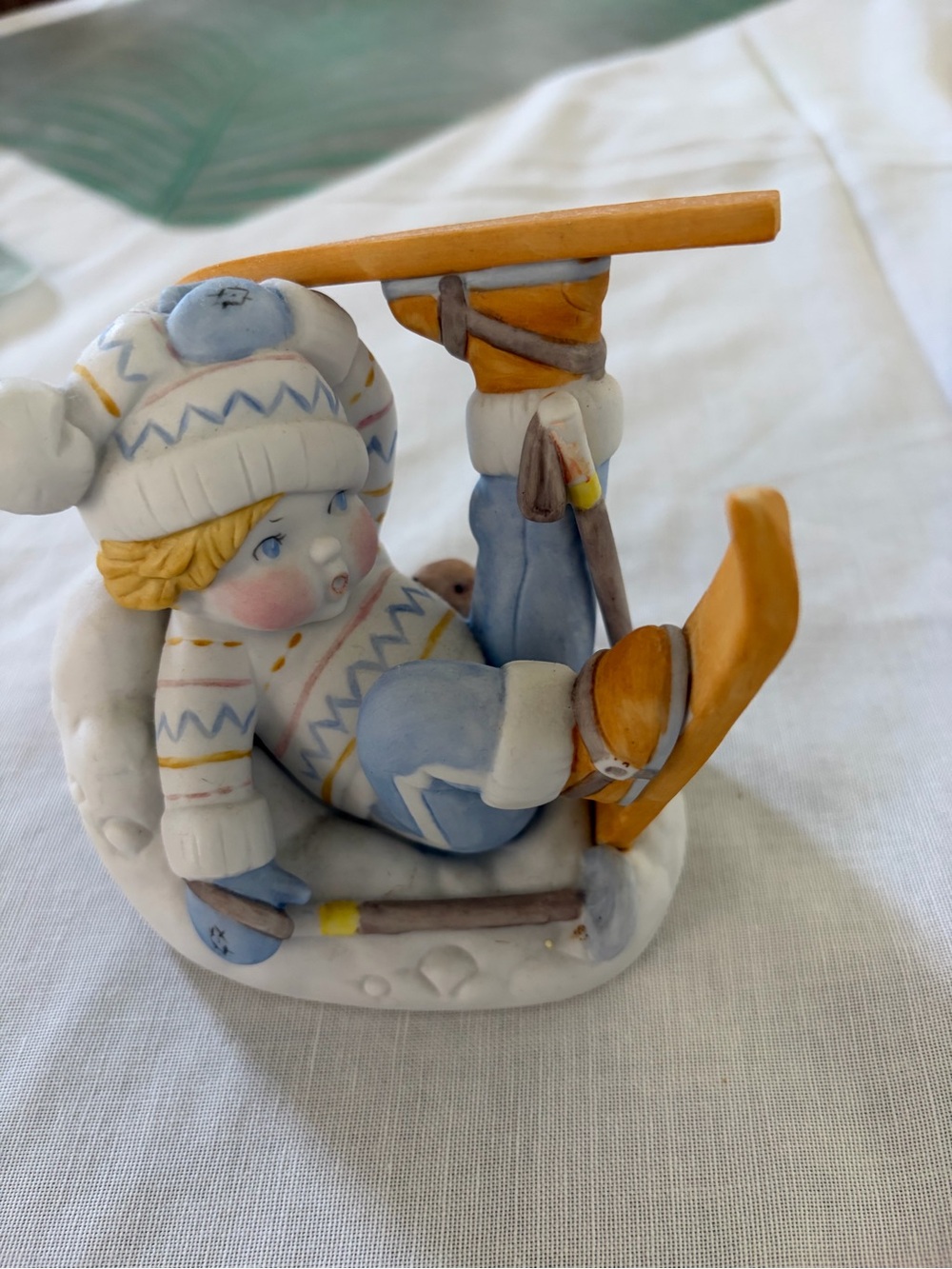 UN Children Porcelain Winter Skier Figurine - Blue and Orange Home Accent.